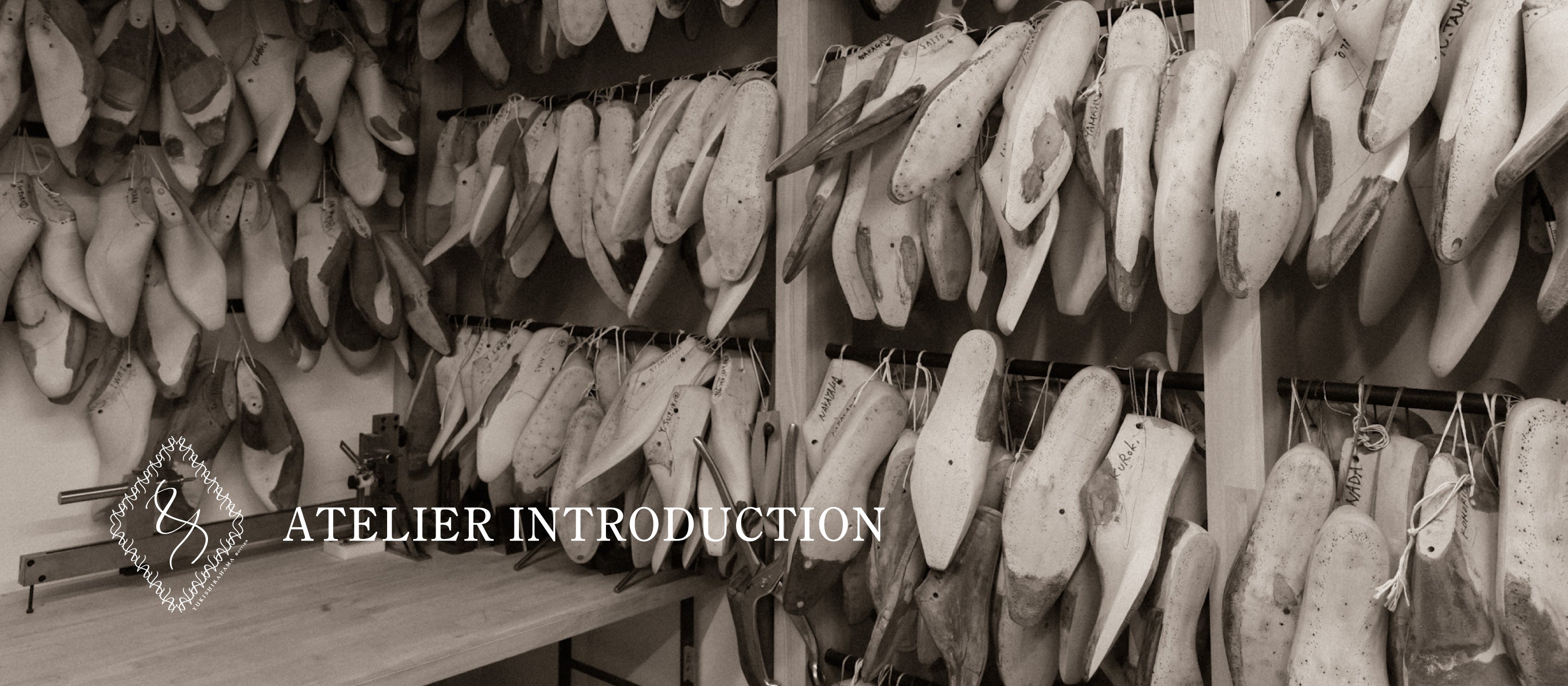 A bespoke shoemaker‘s workshop. Wooden lasts hang from the walls.
Having been used time and again in the creation of bespoke shoes, each one bears numerous nail marks.